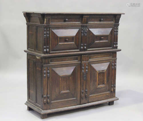 A 17th century and later oak side cabinet, fitted with a dra...