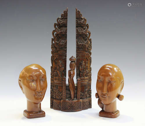 A 20th century Balinese carved hardwood model of a figure st...