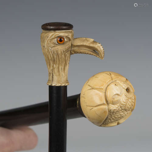 A late 19th/early 20th century ebonized walking cane, the iv...