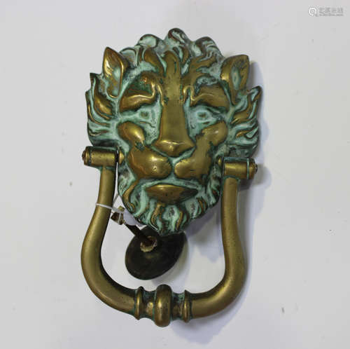 An early 20th century green patinated cast brass door knocke...