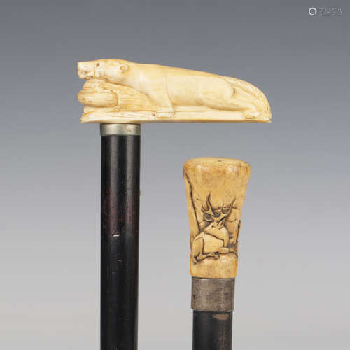 An early 20th century ebonized walking cane, the ivory handl...