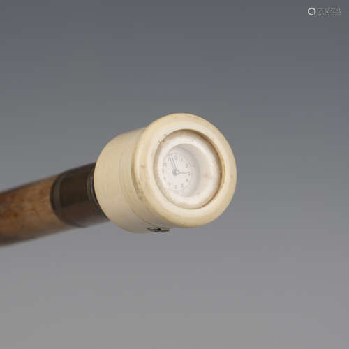 An early 20th century hickory walking cane, the ivory handle...