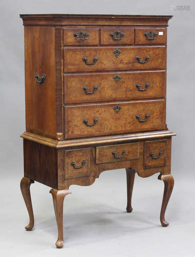 A George I burr walnut chest, raised on a later stand, fitte...