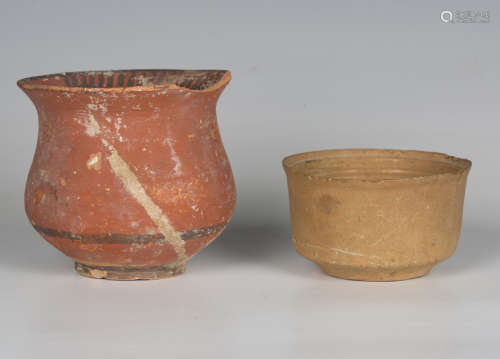 A terracotta pot, probably Mediterranean, with iron red pain...
