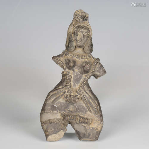 A grey/black pottery figure, probably Indian, modelled weari...