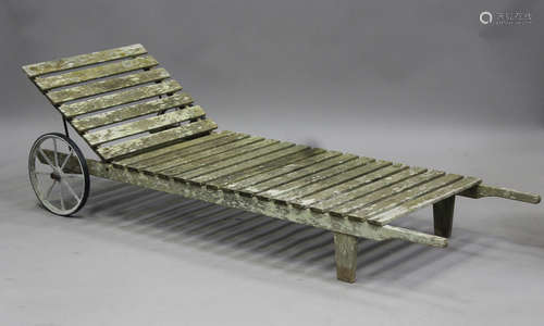 A 20th century slatted wooden garden day bed, fitted with wh...