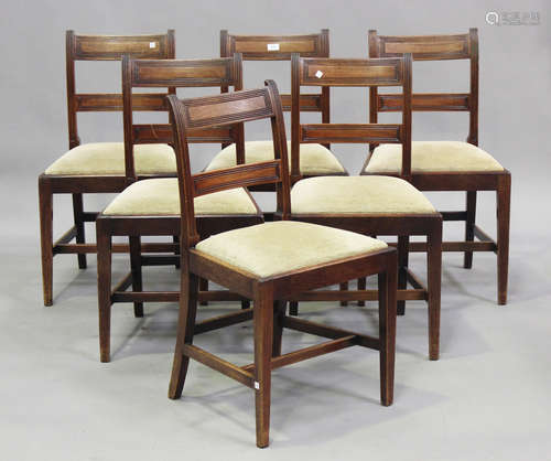 A set of six late George III mahogany bar back dining chairs...