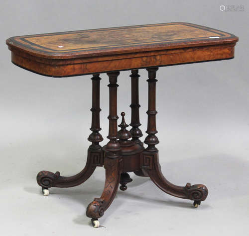 A mid-Victorian walnut fold-over card table, raised on turne...