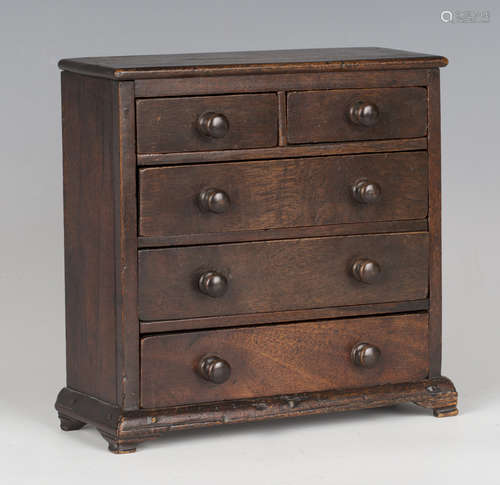 A Victorian mahogany diminutive table-top chest of drawers, ...