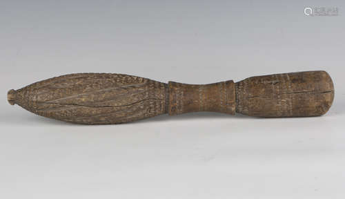 A 19th century ethnic hardwood pestle, carved with overall b...