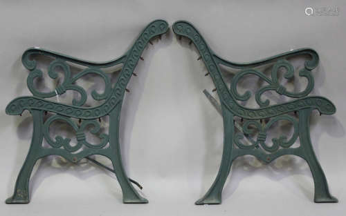 A pair of 20th century green painted cast iron garden bench ...