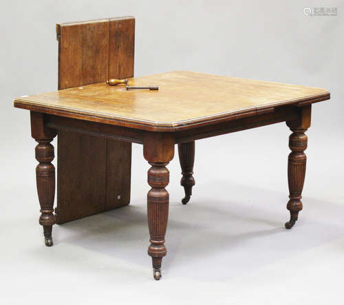 A Victorian mahogany extending dining table with single extr...