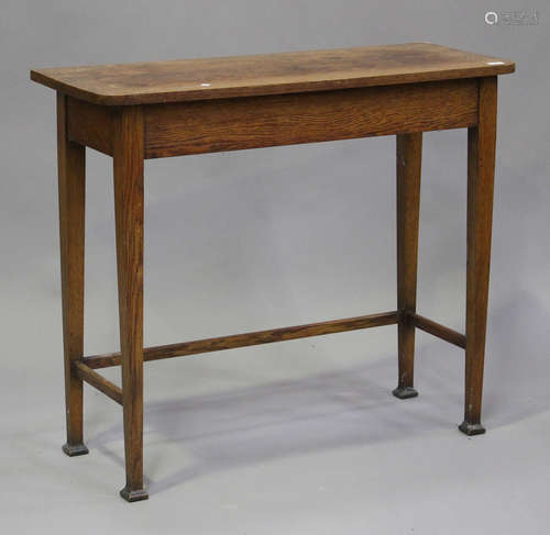 An early 20th century oak hall table, raised on square taper...