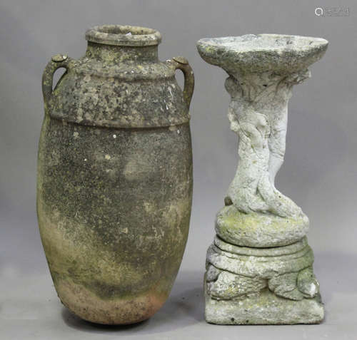 A 20th century cast composition stone bird bath with figural...