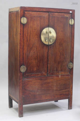 A 19th century Chinese stained elm and brass mounted armoire...
