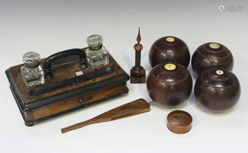 A group of four late 19th century hardwood bowling bowls, a ...