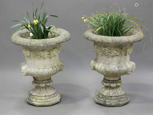 A pair of 20th century cast composition stone garden urns of...