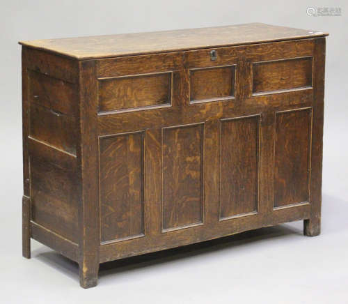 A George III oak coffer, the removable lid above a panelled ...