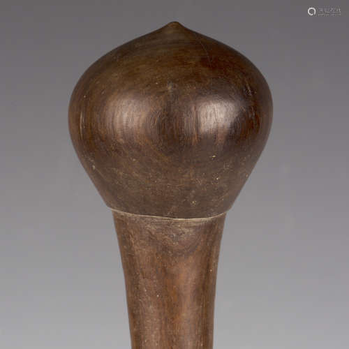 An ethnic carved hardwood club with bulbous end, length 46cm...