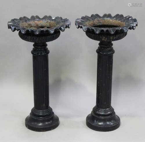 A pair of late Victorian black painted cast iron garden urns...