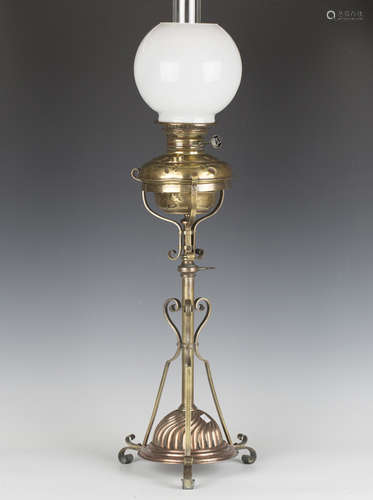 A late Victorian brass and copper mounted table oil lamp wit...