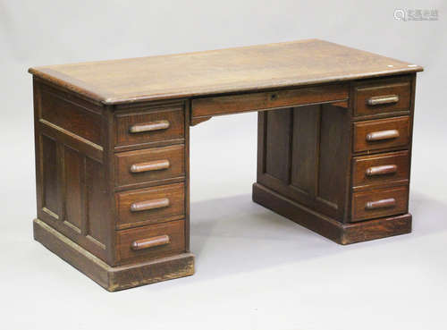 A George V oak twin-pedestal desk, fitted with an arrangemen...