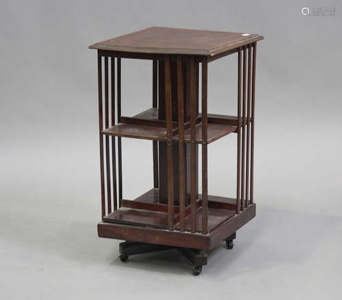 An Edwardian mahogany revolving bookcase, the top with inlai...