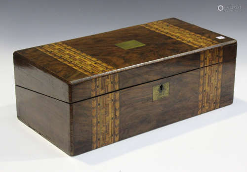 A Victorian walnut writing slope with inlaid geometric bands...