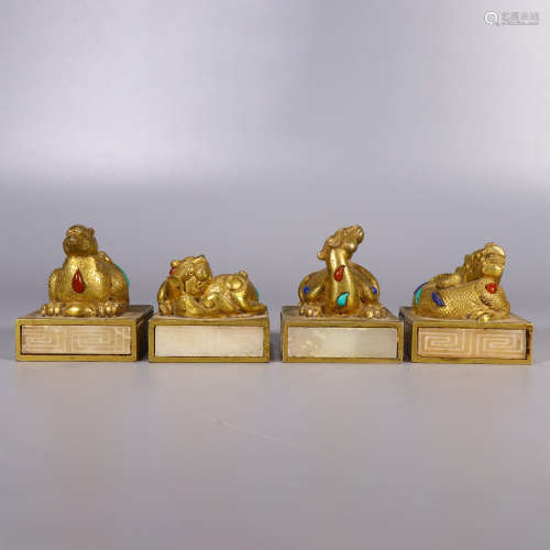 a set of four gilt-inlaid hetian white jade mythical beast s...