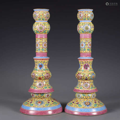 A pair of famille rose interlocking flowers candlesticks