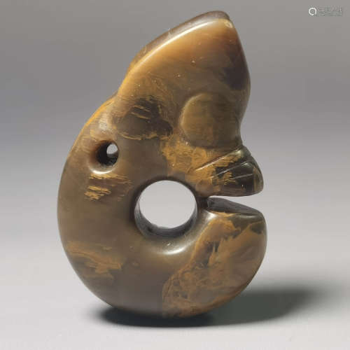 A carved jade dragon pendant