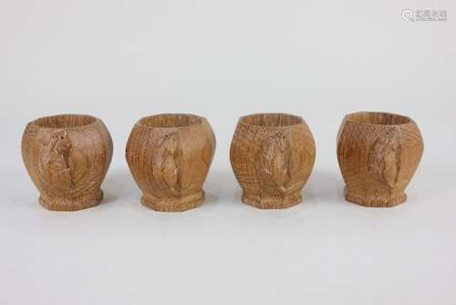 A set of four Robert Mouseman Thompson egg cups, octagonal f...