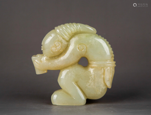 A CARVED WHITE JADE FIGURE