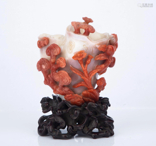 A CARVED RED AGATE FLOWER STAND