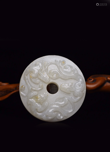 A CARVED WHITE JADE 'DRAGON' BI.QING PERIOD