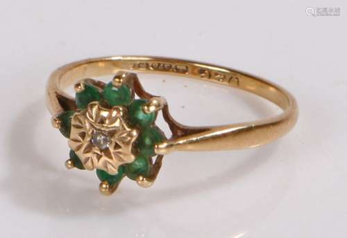 9 Carat gold ring set with green stones in the shape of a fl...