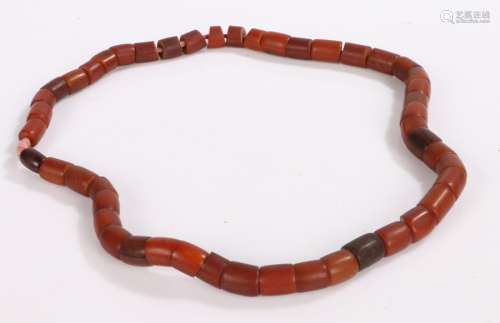 Amber coloured bead necklace, on a string cord