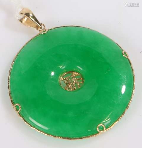 Chinese Jade disc, with 14k gold mount, centred with a chara...