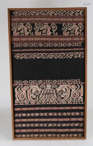 Indonesian textile, housed within a wooden frame, 44cm x 78c...