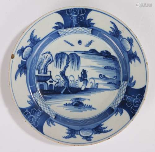 18th Century Delft plate, with a figure looking up at a tree...