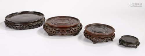 Four carved Chinese stands, each of circular form with fret ...