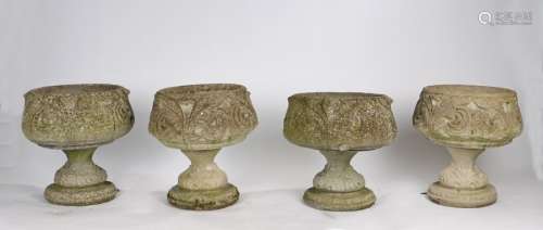Matched of four composite garden urns, with scroll leaf deco...