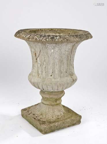 Composite garden urn, with a shaped ribbed body and leaf pli...