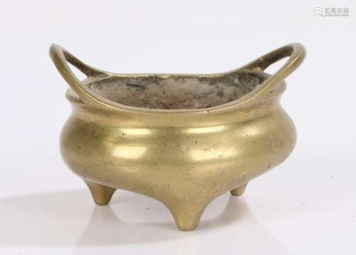 Chinese brass censer, with arched handles above the squat bo...
