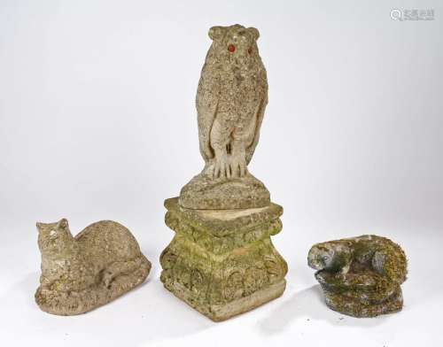 Garden statues, to include an owl, an otter and a cat, toget...