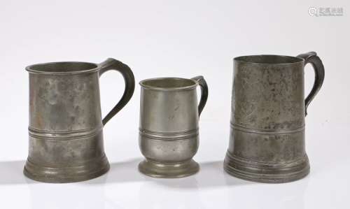 Three pewter tankards, to include a Victorian Quart mug stam...