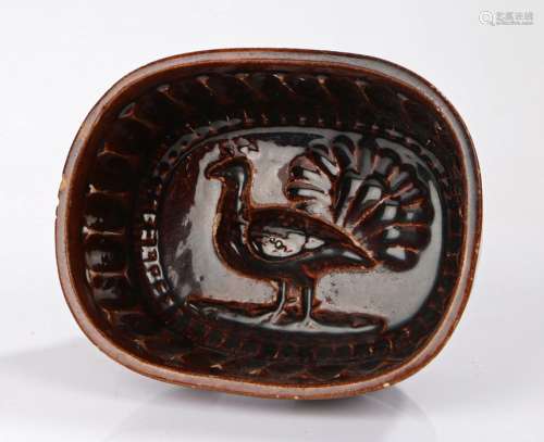 19th Century brown glaze mould, with a peacock to form the i...