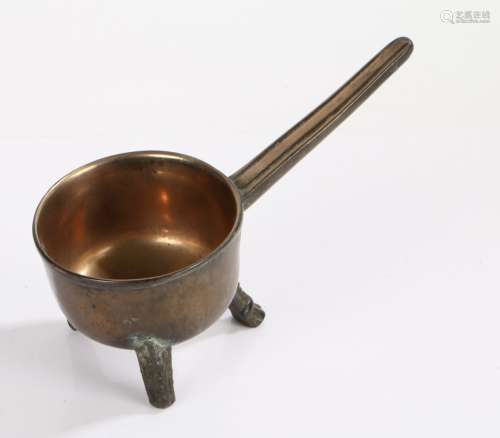 A small bell metal 17th Century skillet, on three legs, the ...