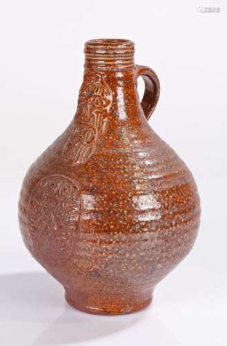 17th Century style pottery Bellarmine jug, in brown glaze wi...