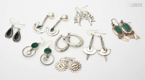 A collection of silver coloured earrings